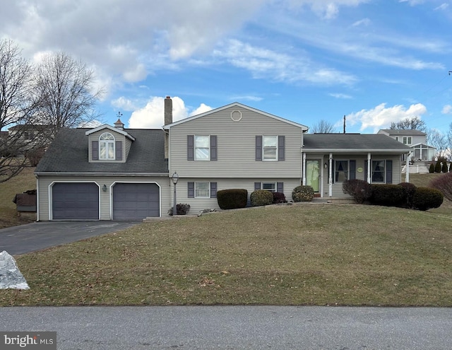 tri-level home with a garage and a front lawn