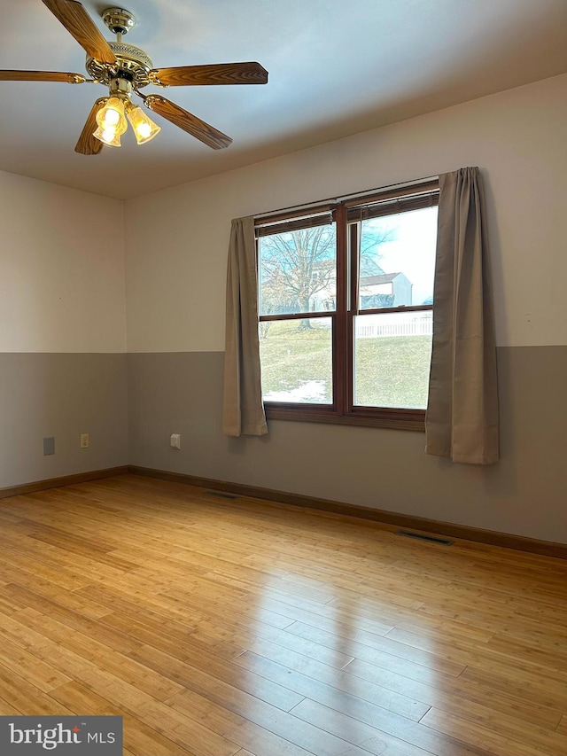 empty room with light hardwood / wood-style floors and ceiling fan