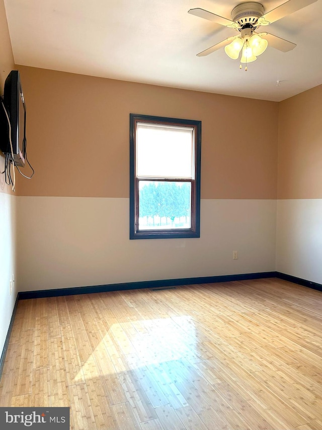 unfurnished room with ceiling fan and light wood-type flooring