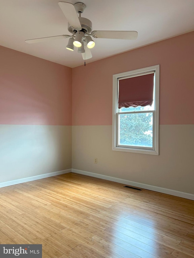 spare room featuring ceiling fan and light hardwood / wood-style floors