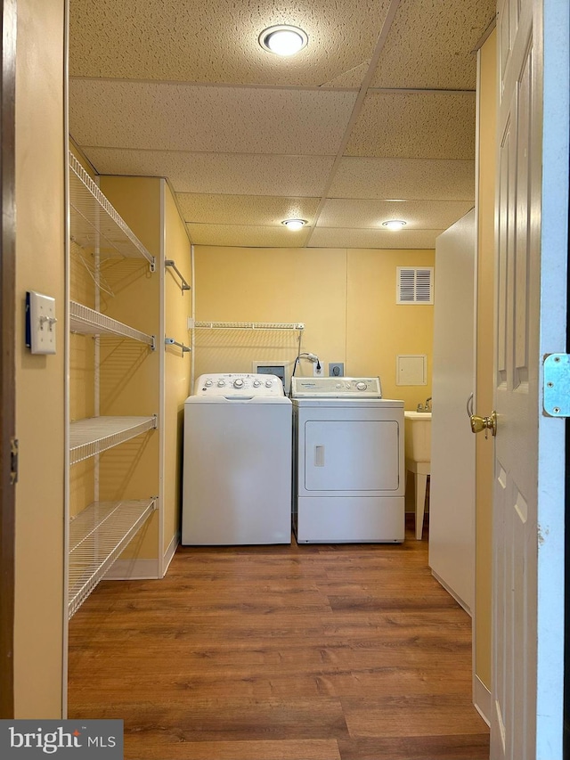 laundry area featuring hardwood / wood-style flooring and washer and dryer