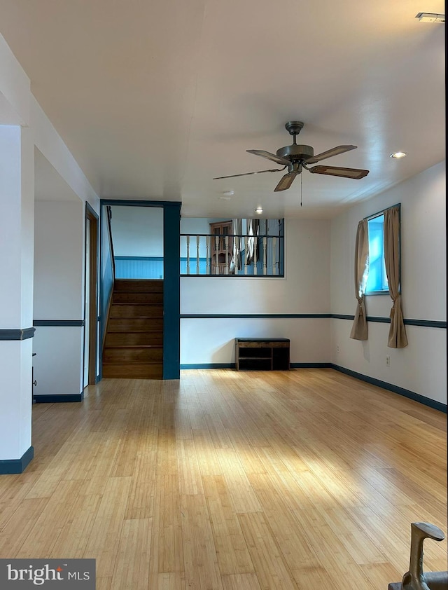 unfurnished living room with light hardwood / wood-style floors and ceiling fan