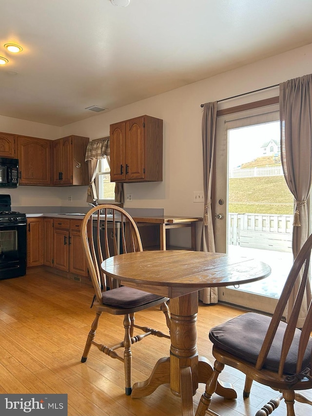 dining area featuring a healthy amount of sunlight and light hardwood / wood-style floors