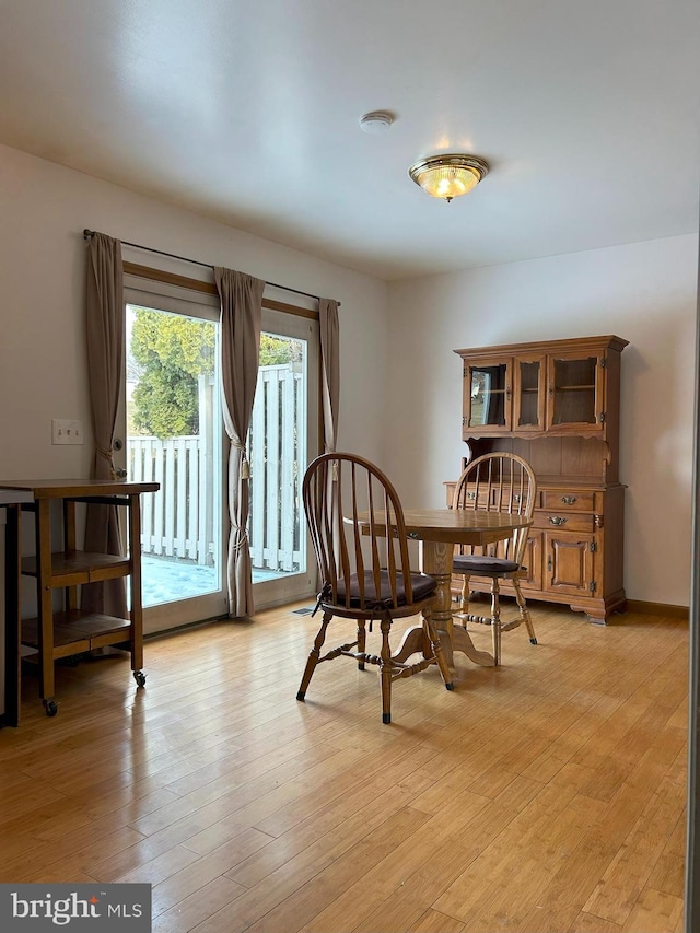 dining area with light hardwood / wood-style flooring