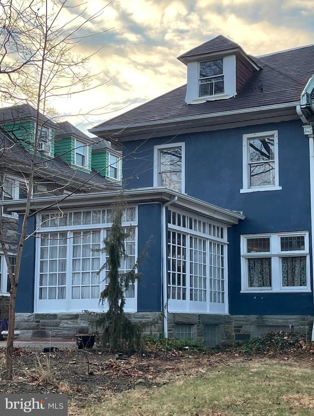 view of back house at dusk