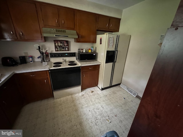 1941 Cedar Dr, Spring Grove, PA 17362 - kitchen featuring electric range oven, under cabinet range hood, white refrigerator with ice dispenser, and light countertops