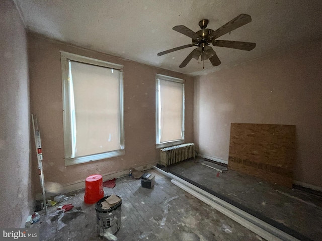 unfurnished room featuring radiator