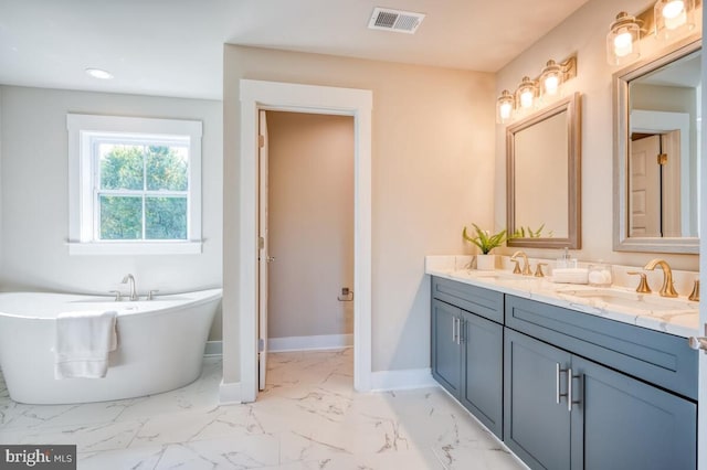 bathroom featuring vanity and a tub