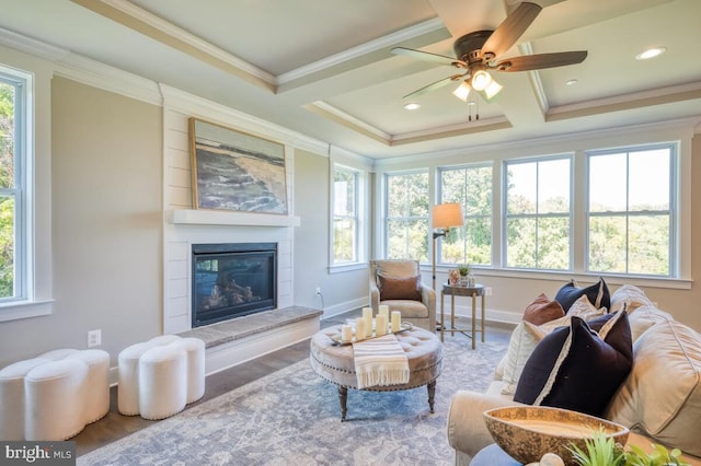 living room with ceiling fan, coffered ceiling, wood-type flooring, ornamental molding, and beamed ceiling