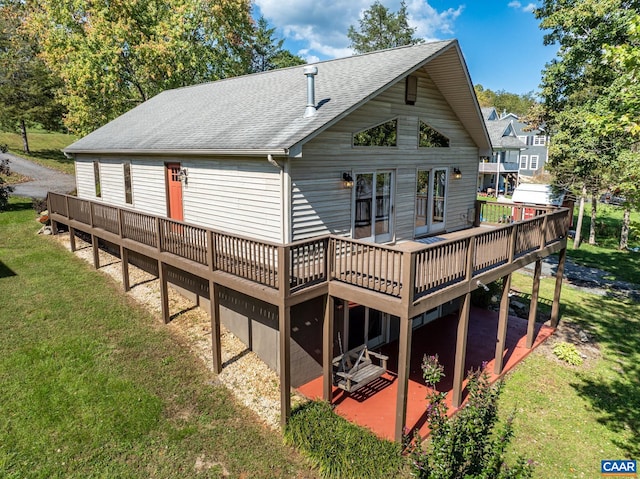 back of house featuring a wooden deck and a yard