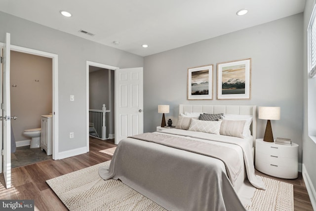 bedroom featuring wood-type flooring and ensuite bath