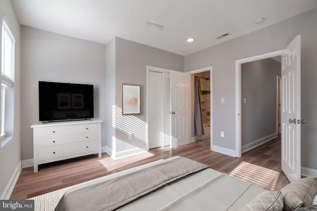 bedroom with a closet and hardwood / wood-style flooring