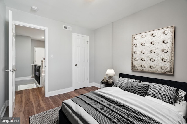 bedroom with dark hardwood / wood-style floors