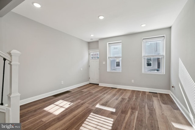 empty room with hardwood / wood-style floors