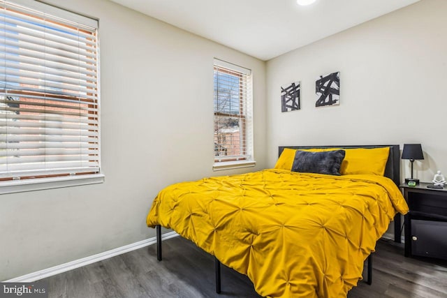 bedroom with dark hardwood / wood-style flooring