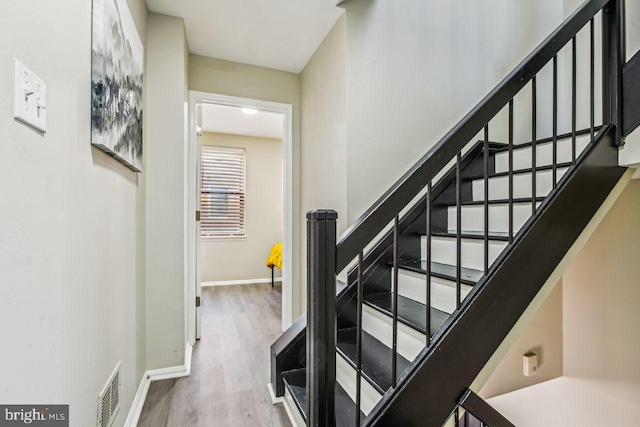 stairs with hardwood / wood-style flooring