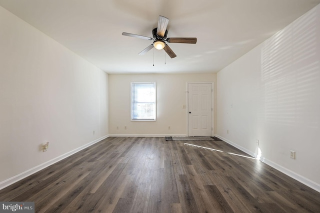 spare room featuring ceiling fan and dark hardwood / wood-style flooring