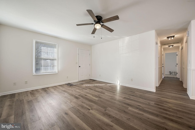 spare room with ceiling fan and dark hardwood / wood-style flooring