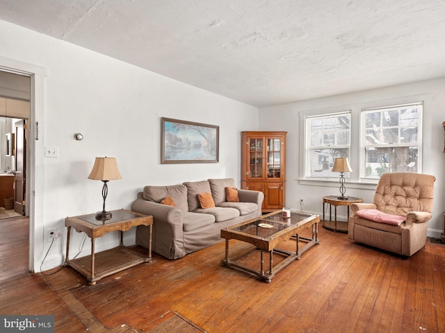 living room with wood-type flooring and a textured ceiling