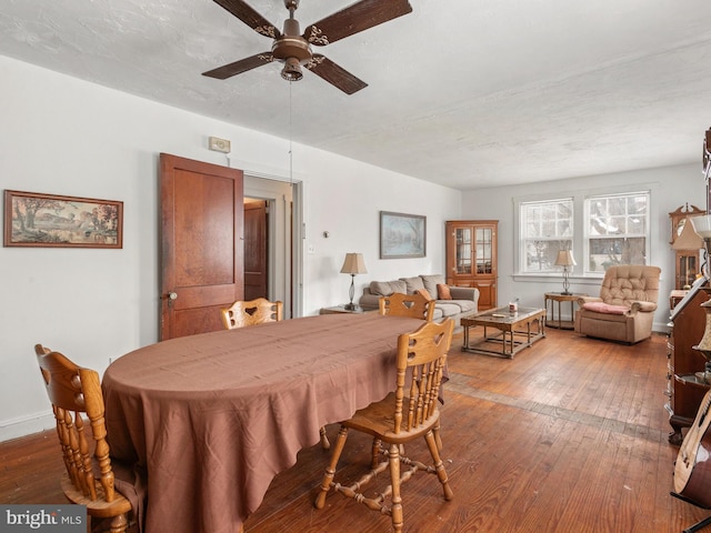 dining space featuring ceiling fan, hardwood / wood-style floors, and a textured ceiling