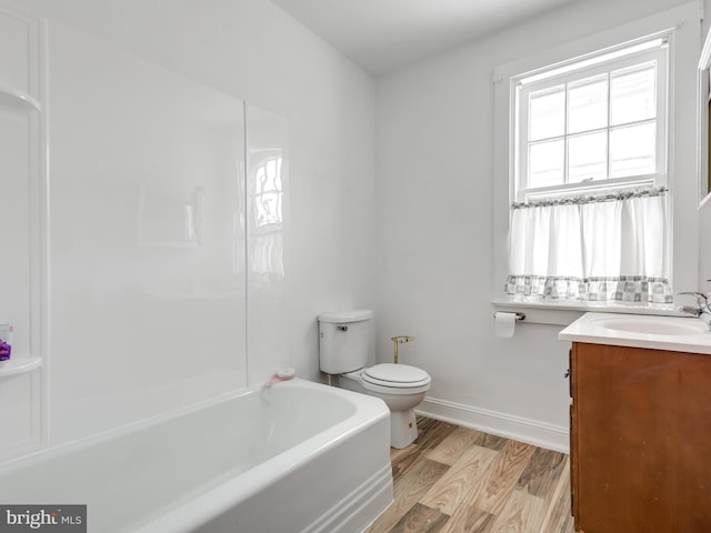 bathroom featuring vanity, a bathing tub, hardwood / wood-style floors, and toilet