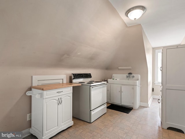 kitchen with vaulted ceiling, white cabinetry, butcher block counters, sink, and white range with electric cooktop