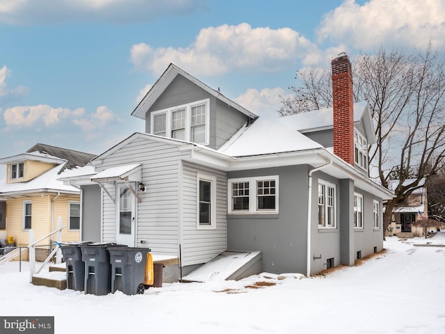 view of snow covered back of property