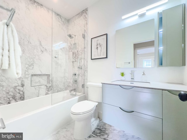 full bathroom featuring toilet, tiled shower / bath, and vanity