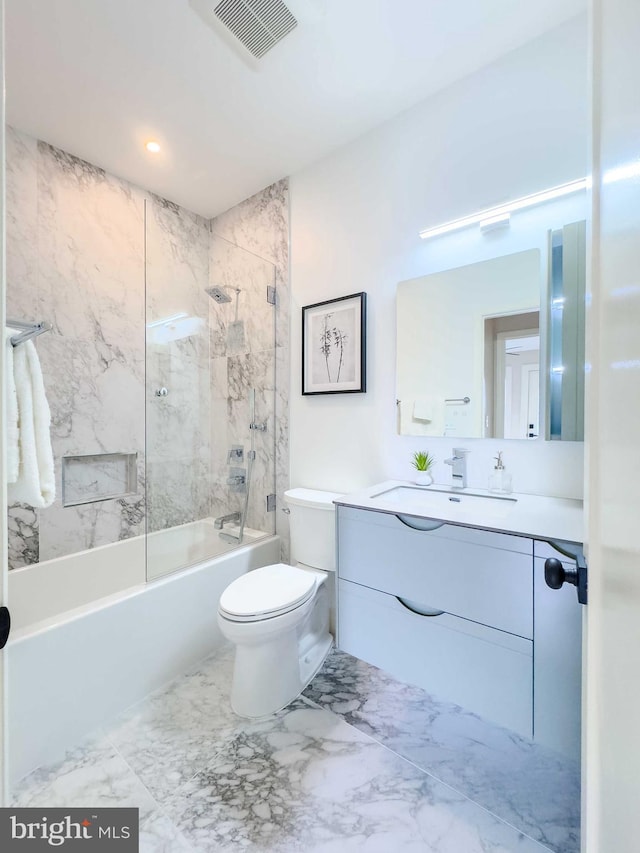 full bathroom with tiled shower / bath combo, toilet, and vanity