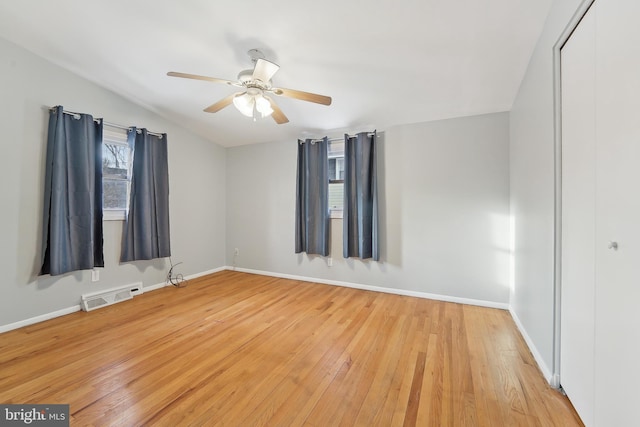 spare room with hardwood / wood-style flooring and ceiling fan