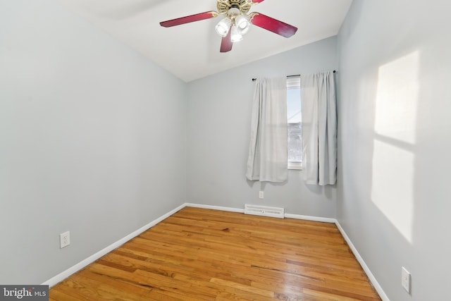 empty room with vaulted ceiling, ceiling fan, and hardwood / wood-style floors