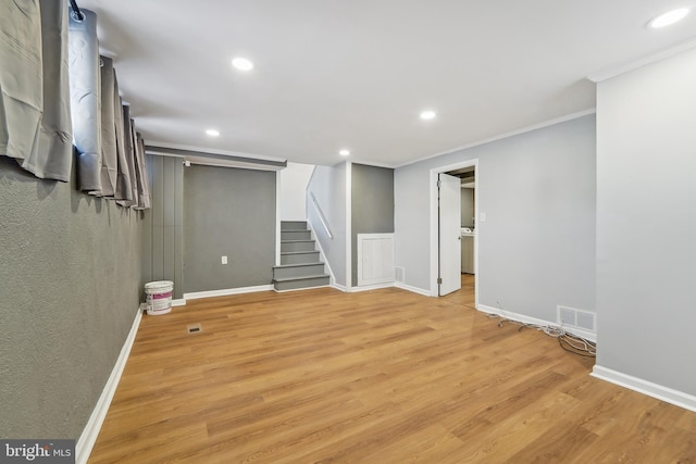 basement featuring crown molding and light wood-type flooring