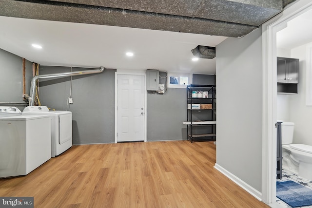 laundry room featuring hardwood / wood-style flooring and separate washer and dryer