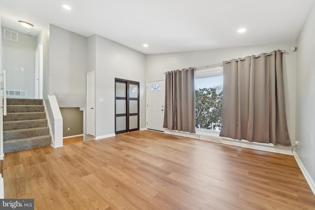 interior space with light wood-type flooring and lofted ceiling