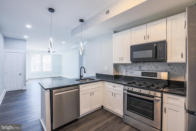 kitchen with pendant lighting, sink, appliances with stainless steel finishes, white cabinetry, and kitchen peninsula