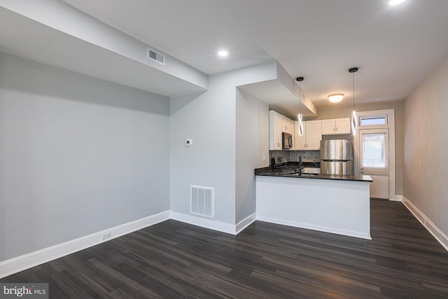 kitchen featuring stainless steel fridge, dark wood-type flooring, white cabinetry, decorative light fixtures, and kitchen peninsula