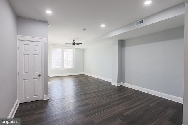 empty room featuring ceiling fan and dark hardwood / wood-style flooring