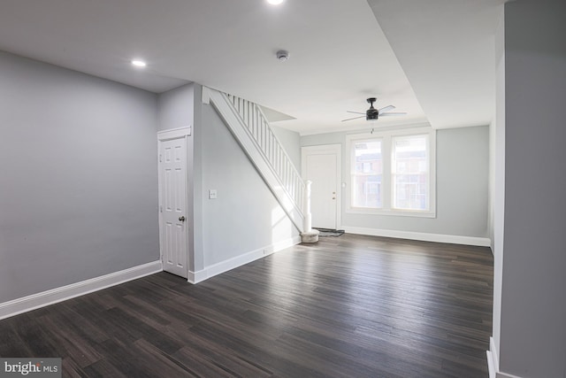 unfurnished living room with ceiling fan and dark hardwood / wood-style floors