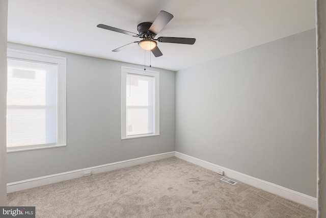 carpeted empty room featuring ceiling fan