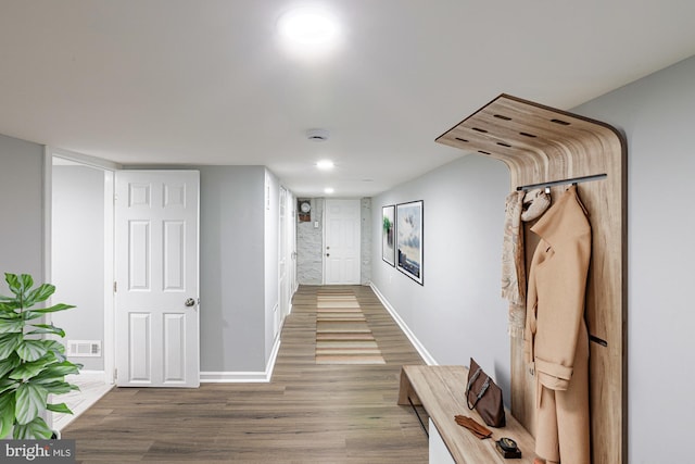 hall with hardwood / wood-style flooring