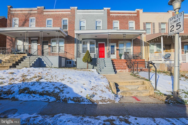 townhome / multi-family property featuring a porch