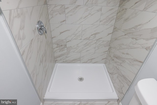 bathroom with a tile shower