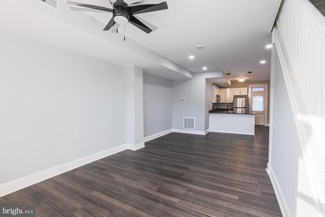 unfurnished living room with dark hardwood / wood-style floors and ceiling fan