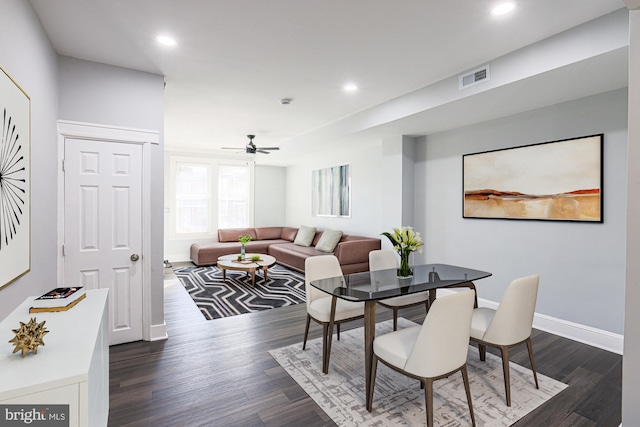 dining space with ceiling fan and dark hardwood / wood-style flooring