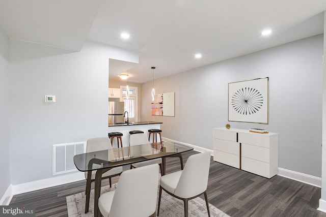 dining area featuring sink and dark hardwood / wood-style floors