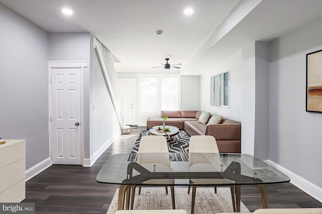 living room featuring ceiling fan and dark hardwood / wood-style flooring