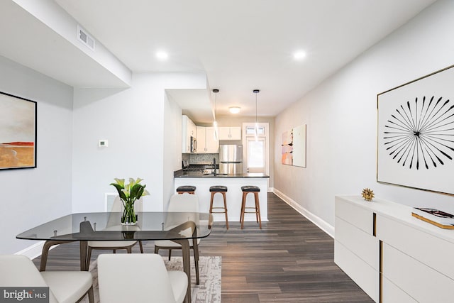 dining area featuring dark hardwood / wood-style flooring