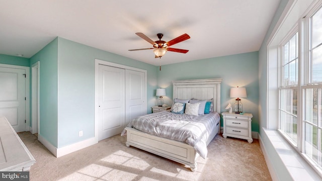 carpeted bedroom featuring a closet and ceiling fan