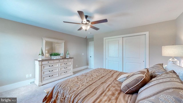 bedroom featuring a closet, ceiling fan, and light colored carpet