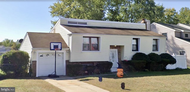 view of front of property with a garage and a front yard